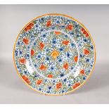 AN 18TH CENTURY POLYCHROME CHARGER. Mark in blue. C.B. with star. 13.5ins diameter.