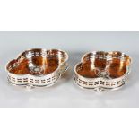 A PAIR OF FAUX TORTOISESHELL AND PLATE SHAPED WINE COASTERS.