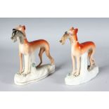 A PAIR OF STAFFORDSHIRE STANDING WHIPPETS with rabbits in their mouths, on waisted, encrusted,