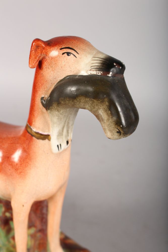 A STAFFORDSHIRE STANDING GREYHOUND, a rabbit in its mouth. 11ins high. - Image 2 of 2