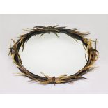 A LARGE ANTLER OVAL MIRROR, the frame entwined with antlers of various sizes. 4ft 6ins high x 3ft