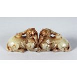 A PAIR OF CHINESE CARVED JADE DOGS OF FO. 3.5ins long.