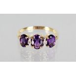 A 9CT GOLD AMETHYST AND DIAMOND RING.