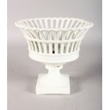 A WHITE PIERCED PEDESTAL FRUIT BOWL. 8.5ins high.