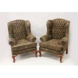 A PAIR OF GEORGE III STYLE BUTTON UPHOLSTERED WING ARMCHAIRS, on cabriole legs.