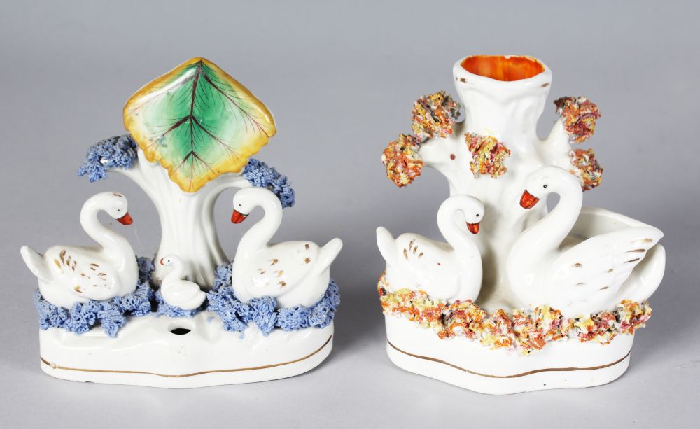 A STAFFORDSHIRE SWAN SPILL VASE with two swans and tree stump, on a shaped, encrusted base, 4.