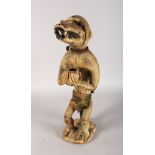 AN EARLY WOODEN TRIBAL BAULE FIGURE of a monkey. 22ins high.