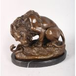AFTER A. BARYE A BRONZE LION WITH A SNAKE. Signed. 8.5ins, on an oval marble base.