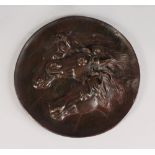 A BRONZE PLAQUE, POSSIBLY AFTER ROSA BONHEUR 1822-1899, depicting three horses. Tondo 8.5ins