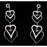 A PAIR OF WHITE GOLD DIAMOND SET INTERLOCKING HEART DROP EARRINGS.