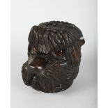 A CARVED WOOD BLACK FOREST SHAGGY DOG TEA CADDY with glass eyes. 7ins high.