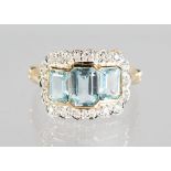 A 9CT GOLD EMERALD CUT BLUE TOPAZ AND DIAMOND RING.