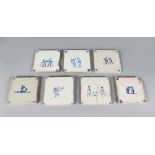 A SET OF SEVEN 19TH CENTURY BLUE AND WHITE TILES with figures playing games etc. 5ins square.