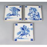 A SET OF THREE LATE 19TH CENTURY BLUE AND WHITE TILES, Circa. 1880-1900, Jousting. 6ins square.