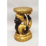 A CARVED AND GILDED BLACKAMOOR STAND, modelled as a crouching figure holding a cushion aloft. 1ft