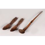 THREE AFRICAN CARVED WOODEN SPOONS. Largest: 16ins (3).