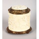 A EUROPEAN CARVED IVORY TUSK BOX AND COVER, carved with a hunting scene and metal mounts. 4ins