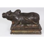 AN 18TH/19TH CENTURY INDIAN BRONZE NANDI, the South Indian cow with a prominent hump, 6.3in long &
