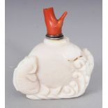 A CHINESE WHITE HARDSTONE SNUFF BOTTLE & CORAL STOPPER, the bottle carved with carp leaping from