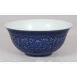 A CHINESE MING STYLE BLUE GLAZED PORCELAIN BOWL, the sides with underglaze moulded formal floral