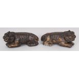 A PAIR OF CHINESE GILT BRONZE BUDDHISTIC LION SCROLL WEIGHTS, 5in long & 2.3in high.