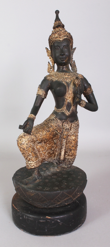 A 20TH CENTURY THAI GILT BRONZE OF A KNEELING THEPHANOM FIGURE, supported on a circular carved