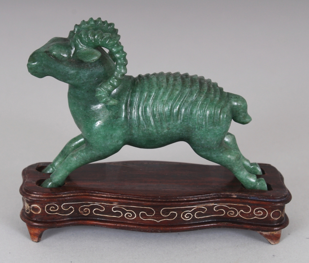 A CHINESE GREEN HARDSTONE MODEL OF A RAM, together with a fitted wire-inlaid wood stand, 3.1in