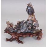 A CHINESE CARVED AGATE MODEL OF A PEACOCK, seated on rockwork in the company of a cat and a small