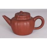 A 19TH CENTURY CHINESE YIXING FLUTED POTTERY TEAPOT, LINER & COVER, the cover moulded with a