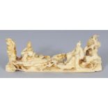 AN UNUSUAL 19TH CENTURY CHINESE IVORY BRUSH REST OF A SAGE AND HIS ATTENDANT, seated on rockwork