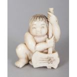 A SIGNED JAPANESE MEIJI PERIOD IVORY NETSUKE OF A SQUATTING BOY HOLDING AN AXE, the base with an