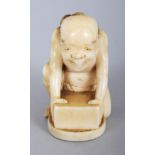 A SIGNED JAPANESE MEIJI PERIOD IVORY NETSUKE OF A KNEELING MAN CLAD IN A LOIN CLOTH, possibly a