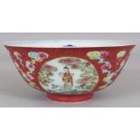 A CHINESE PINK GROUND FAMILLE ROSE MEDALLION BOWL, the panels reserved on a sgraffiato ground, the