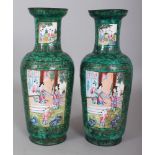 A PAIR OF 19TH CENTURY CHINESE GREEN GROUND CANTON ENAMEL VASES, decorated with vividly coloured