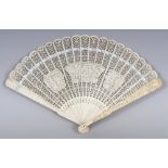 A GOOD 19TH CENTURY CHINESE CANTON IVORY FAN, the nineteen thin inner sticks carved with shaped