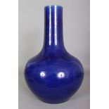 A LARGE 19TH CENTURY CHINESE BLUE GLAZED PORCELAIN BOTTLE VASE, the base unglazed, 11.5in wide at