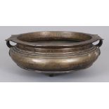 AN EARLY 20TH CENTURY ORIENTAL BRONZE CENSER, weighing 2.49Kg, the sides with double strap