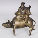 A CHINESE BRONZE CENSER & COVER, cast in the form of a sage seated on the back of a water buffalo,
