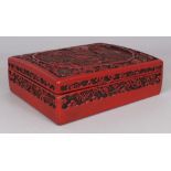 A CHINESE RED CINNABAR LACQUER STYLE RECTANGULAR BOX & COVER, the cover decorated with a