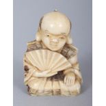 A SMALL JAPANESE MEIJI PERIOD IVORY OKIMONO OF A KNEELING MAN, holding an open fan, 1.75in high.