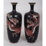 A PAIR OF JAPANESE MEIJI PERIOD BLACK GROUND CLOISONNE DRAGON VASES, 6in high.