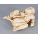 AN UNUSUAL EARLY 20TH CENTURY SIGNED JAPANESE EROTIC IVORY OKIMONO, in the form of a reclining