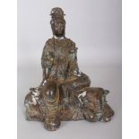 A CHINESE BRONZE MODEL OF GUANYIN SEATED ON THE BACK OF AN ELEPHANT, the reverse and base each