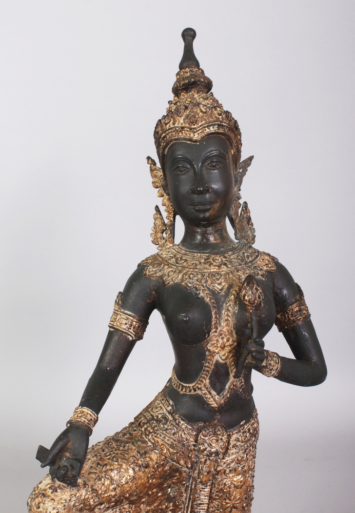 A 20TH CENTURY THAI GILT BRONZE OF A KNEELING THEPHANOM FIGURE, supported on a circular carved - Image 3 of 4