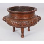 A CHINESE BRONZE TRIPOD CENSER, weighing approx. 1.03Kg, the sides cast with lion-head handles and