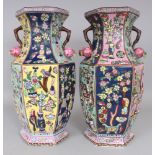 A LARGE PAIR OF CHINESE FAMILLE ROSE HEXAGONAL SECTION MOULDED PORCELAIN VASES, each base with a