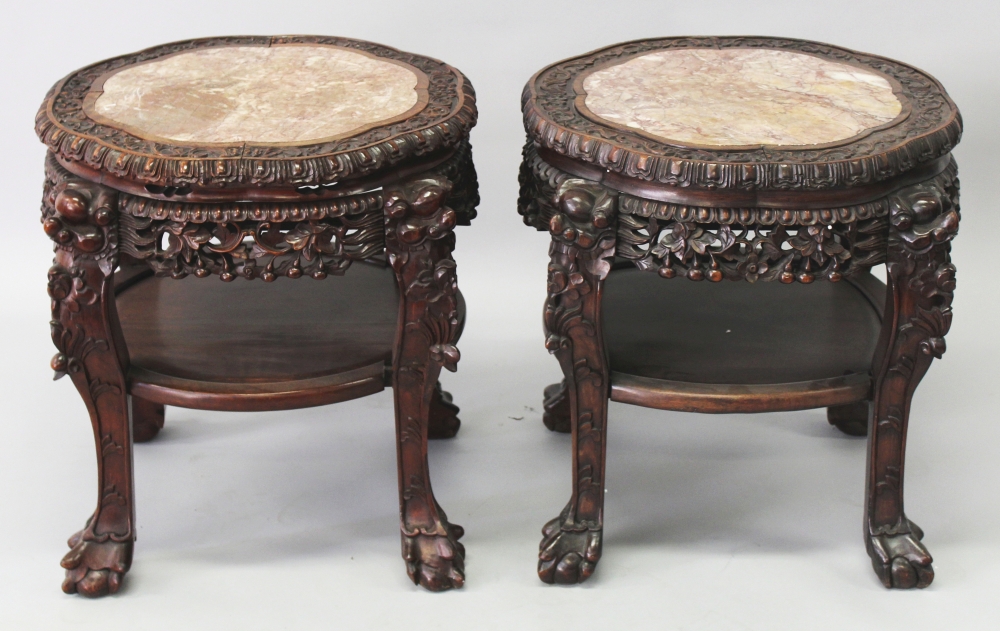 A PAIR OF FINE QUALITY 19TH CENTURY CHINESE PINK MARBLE TOP CARVED HARDWOOD STANDS, each pierced and