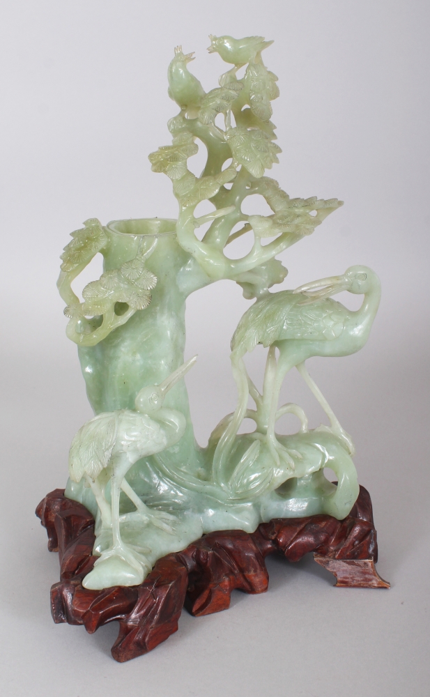 A CHINESE JADE-LIKE CELADON GREEN HARDSTONE VASE CARVING, together with a fitted wood stand,