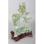 A CHINESE JADE-LIKE CELADON GREEN HARDSTONE VASE CARVING, together with a fitted wood stand,