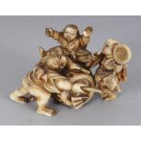 A GOOD QUALITY SIGNED JAPANESE MEIJI PERIOD STAINED IVORY OKIMONO OF THREE BOYS PLAYING AROUND A
